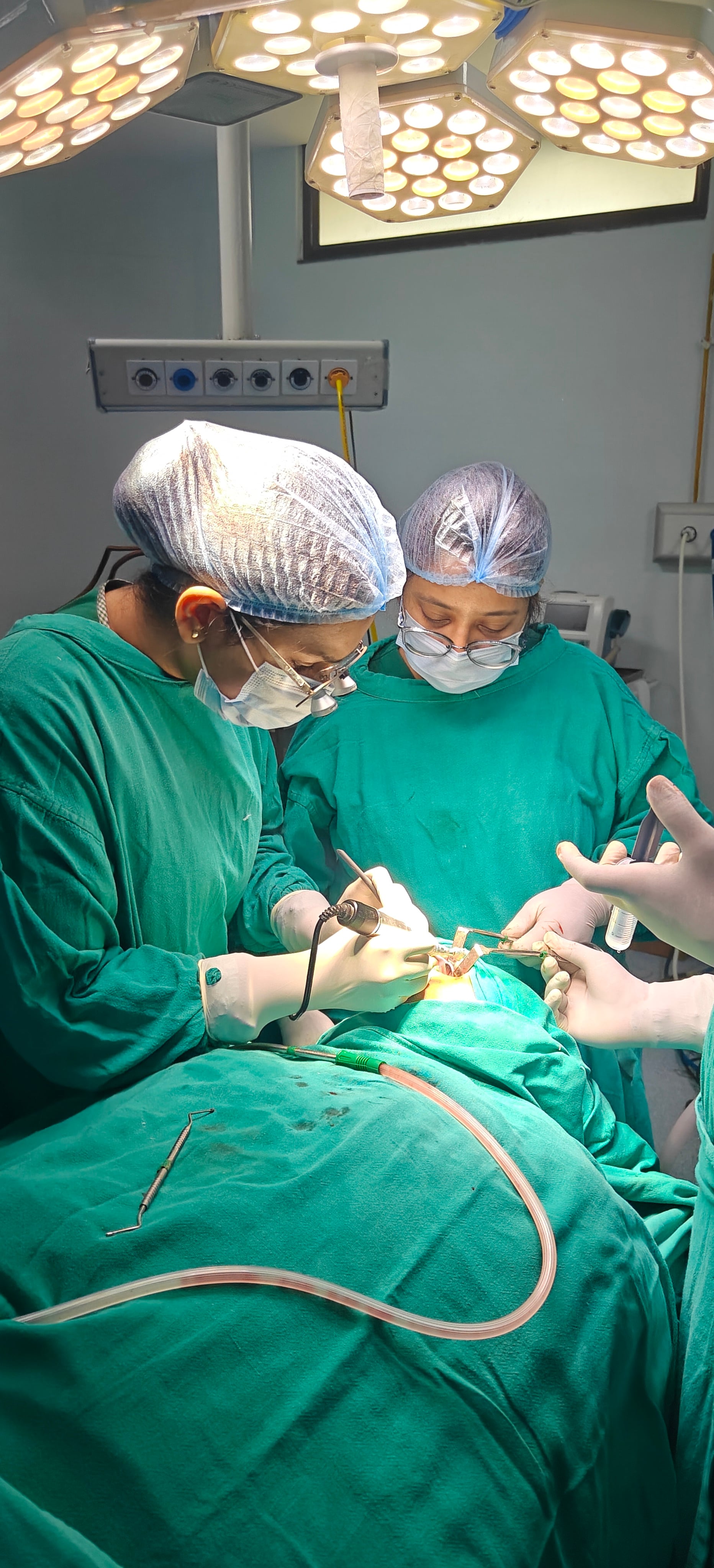 Dr. Bhavya Soni operating with precision instruments during dental surgery